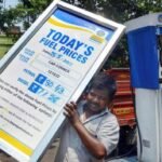 Fuel price display board at an Indian petrol pump showing petrol, diesel and CNG rates.