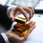 Gold bars and financial market trading visuals showing investment trends.