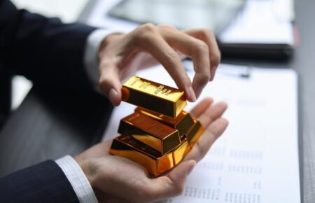 Gold bars and financial market trading visuals showing investment trends.