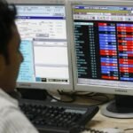 Investors tracking Indian stock market gains on trading screens.
