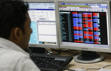 Investors tracking Indian stock market gains on trading screens.