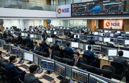Investors monitoring stock market data on trading screens at an Indian stock exchange.